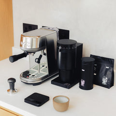 A steel Sage Bambino coffee machine featuring a compact design, fast ThermoJet heating, manual steam wand, and PID temperature control for making barista-quality coffee at home.