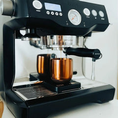 A black Sage Dual Boiler espresso machine with dual stainless steel boilers, PID temperature control, and manual steam wand for precise, barista-quality coffee brewing at home