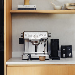 A steel Sage Dual Boiler espresso machine with dual stainless steel boilers, PID temperature control, and manual steam wand for precise, barista-quality coffee brewing at home